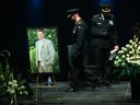 OPP Commisioner Thomas Carrique (centre left) leaves the stage after speaking at the funeral service of OPP Sgt. Eric Mueller in Ottawa on Thursday, May 18, 2023. Sgt. Mueller (in the picture on the stand) was killed last week while responding to a call with two other officers in Bourget, Ont.