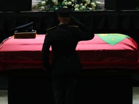 OPP Commissioner Thomas Carrique salutes in front of the casket after speaking at the funeral service of OPP Sgt. Eric Mueller in Ottawa on Thursday. Sgt. Mueller was killed last week while responding to a call with two other officers in Bourget.