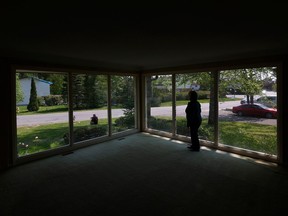 Dale Faris, sitting outside, and his wife Hilary Faris are still waiting for repairs to be completed on their home in the Pineglen neighbourhood, damaged by the derecho on May 21, 2022, but hope to be able to move back in next month.