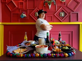 Chef Elisa Calvo with a spread of food at Aztec Tacos at 77 Montreal Road in Ottawa Tuesday.