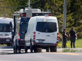 Police block off the area outside a home on Laval Street in Bourget, Ont. Friday morning — the scene of a shooting Thursday involving three Ontario Provincial Police officers.