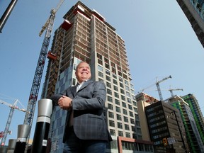 RIMAP Hospitality's Stephane Pelletier stands in front of the first of three hotels under construction.