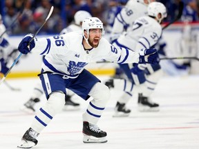 Erik Gustafsson #56 of the Toronto Maple Leafs celebrate winning Game Six of the First Round of the 2023 Stanley Cup Playoffs on an overtime goal by John Tavares #91 against the Tampa Bay Lightning at Amalie Arena on April 29, 2023 in Tampa, Florida.
