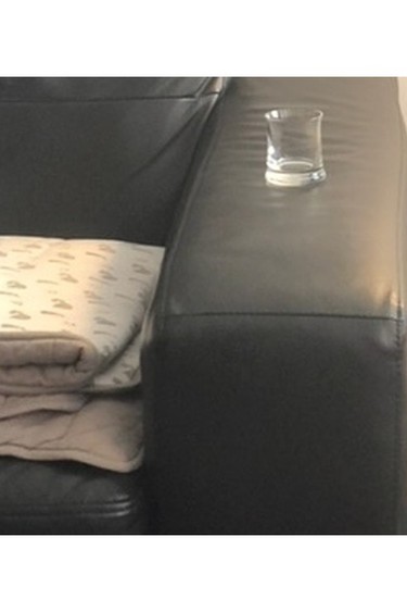 Dessaulles texted his client this picture of a blanket next to an empty shot glass.