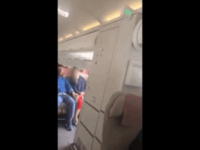 Passengers on a plane with a door opened in flight