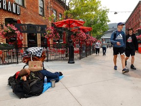 A homeless man resting in the ByWard Market in Ottawa Tuesday.