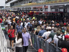 Race fans walk through pit lane during the open house at the Canadian Grand Prix Thursday, June 15, 2023, in Montreal. Residents and tourists, alike, are excited for the return of the Canadian Grand Prix, the unofficial kickoff to the city's summer festival season.
