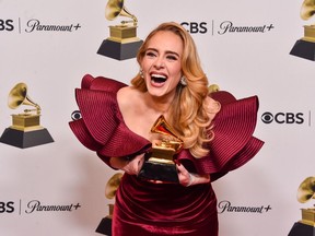 Adele poses with her Best Pop Solo Performance Award for Easy on Me during the 65th Grammy Awards in Los Angeles.
