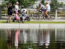 People of different ages and modes of transportation enjoy the pond between the Rideau Canal and the Queen Elizabeth Driveway in this 2021 file photo.