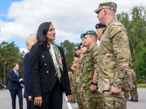 Then-defence minister Anita Anand, left, meets the Canada-led multinational NATO enhanced Forward Presence Battle Group at the Adazi military base in Riga, Latvia, on July 10.