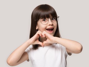 young girl happily wearing glasses