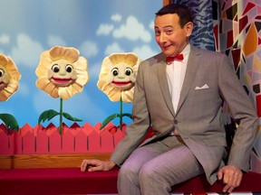 In this 2010 photo, Paul Reubens, in character as Pee-wee Herman, poses on stage after a performance of The Pee-wee Herman Show on Broadway in New York.