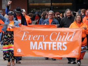 Survivors of the Residential School System and Sixties Scoop lead a march through Fort McMurray, Alta., for the National Day for Truth and Reconciliation on Sept. 30, 2022.