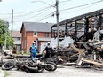 Motorcycles recovered from an Outlaws clubhouse lie in the foreground Tuesday