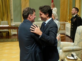 Prime Minister Justin Trudeau hugs Minister of Public Safety, Democratic Institutions and Intergovernmental Affairs Dominic LeBlanc