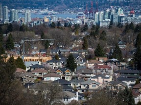 FILE: A condo building is seen under construction surrounded by houses as condo towers are seen in the distance in Vancouver, B.C., on Friday March 30, 2018.