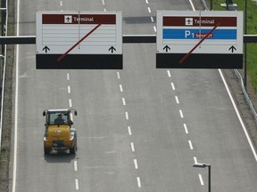 FILE: A forklift drives past terminal direction signs at the the construction site of the new Willy Brandt Berlin Brandenburg International Airport on May 8, 2012 in Berlin, Germany.