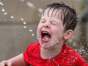 Jaxen Ineson, 3, wanted water any way he could get it as temperatures soared to 32 degrees and felt like 40 degrees with the humidex Tuesday in Ottawa.