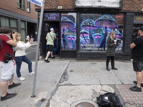 Media gather at the opening of the Fun Guyz magic mushroom store, in Montreal, Tuesday, July 11, 2023. The shop specializes in psychedelic mushrooms, which are illegal in Quebec.