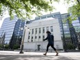 A woman walks past the Bank of Canada headquarters in Ottawa.