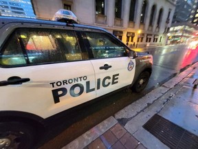 A Toronto police vehicle is shown parked on Yonge Street as rain falls in downtown Toronto on Tuesday Jan. 3, 2023.