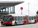 An R1 bus waits at OC Transpo's Cyrville LRT station. July's decline in train and bus ridership was reflected in fare revenue, which at $8.3 million.