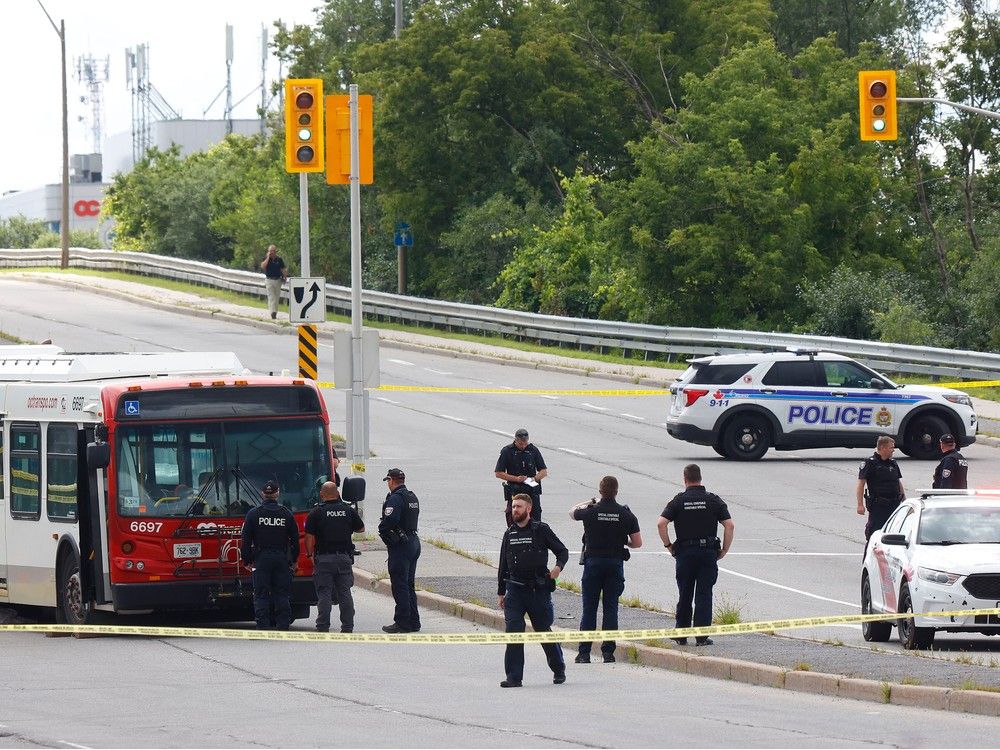 Ottawa police investigate a collision involving an OC Transpo bus and a pedestrian near the corner of St. Laurent Boulevard and Tremblay Road in Ottawa Thursday.