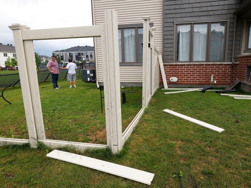 Families go outside their home to check out the damage to their homes and neighbourhood after a tornado rips through Barrhaven