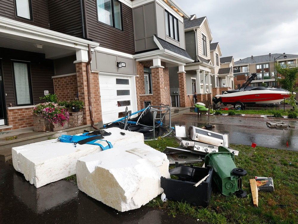 Families go outside their home to check out the damage to their homes and neighbourhood after a tornado rips through Barrhaven