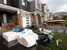 Families go outside their home to check out the damage to their homes and neighbourhood after a tornado rips through Barrhaven