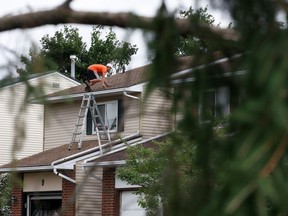Families go outside their home to check out the damage to their homes and neighbourhood after a tornado rips through Barrhaven