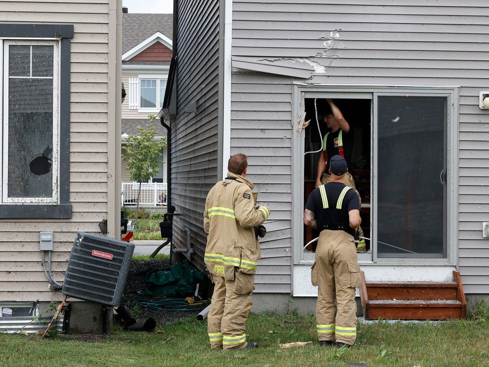 Families go outside their home to check out the damage to their homes and neighbourhood after a tornado rips through Barrhaven