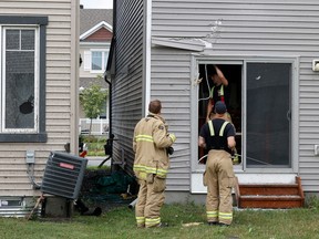 Families go outside their home to check out the damage to their homes and neighbourhood after a tornado rips through Barrhaven