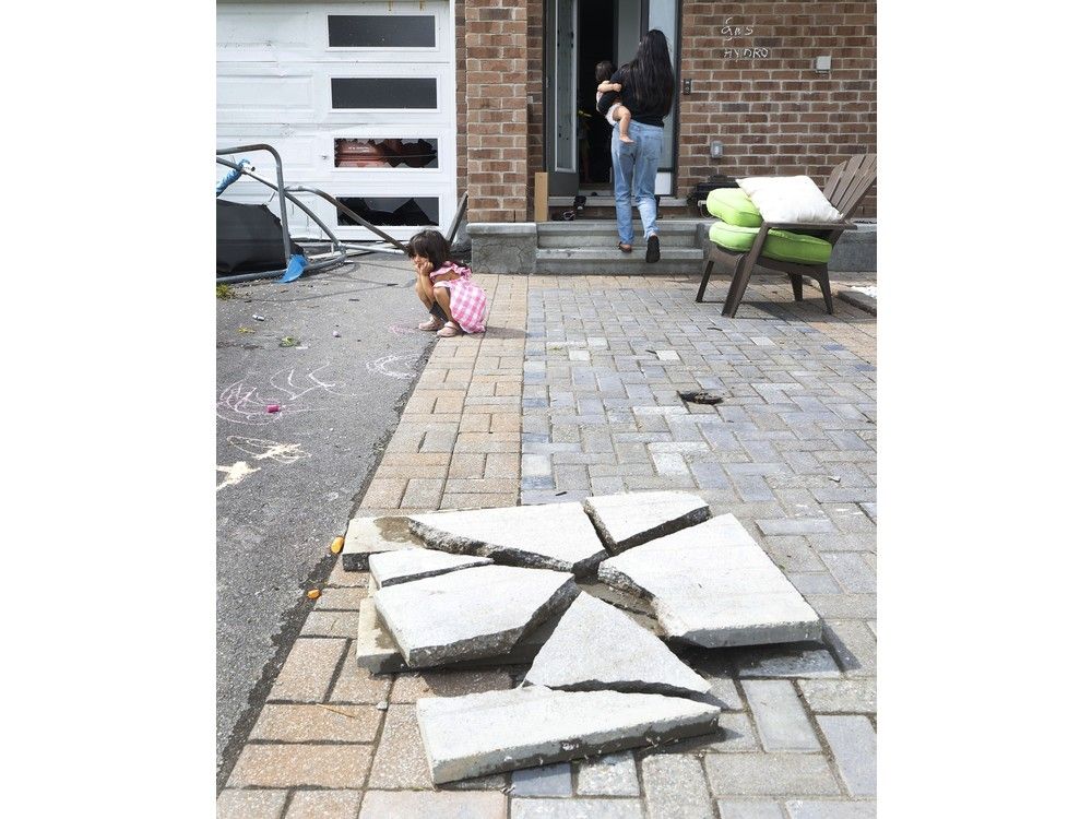 Families go outside their home to check out the damage to their homes and neighbourhood after a tornado rips through Barrhaven