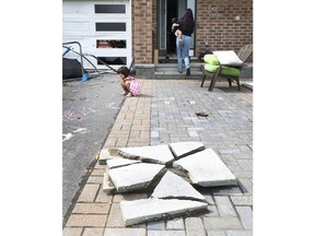 Families go outside their home to check out the damage to their homes and neighbourhood after a tornado rips through Barrhaven