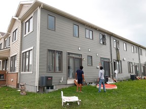 Families go outside their home to check out the damage to their homes and neighbourhood after a tornado rips through Barrhaven