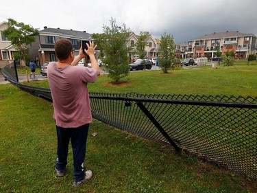 Families go outside their home near Merak Park to check out the damage to their homes and neighbourhood after a tornado rips through Barrhaven