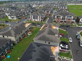 Families go outside their home to check out the damage to their homes and neighbourhood after a tornado rips through Barrhaven