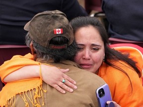 An Indigenous woman cries while hugging a loved one as Pope Francis speaks during a public event in Iqaluit during his visit in July 2022. Almost half of Canadians blame the Catholic Church for the trauma of residential schools.