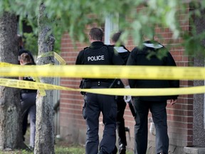 Police taped off an area in front of supportive housing units at 1 Nelson St.