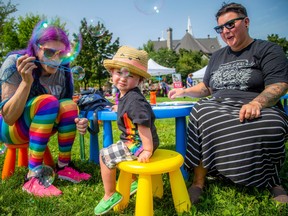 Capital Pride held a family picnic in Hintonburg Park on Sunday to celebrate 2SLGBTQ+ families. Steph and Em (right) Kraemer were there with their almost-two-year-old child, having fun blowing bubbles.