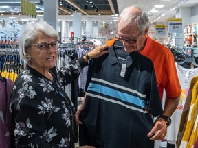 Joanne and Michel Côté shop at a Zellers pop-up store in a Hudson's Bay store in Brossard on Friday Aug. 11, 2023.