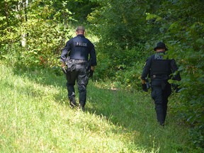 Officers with the Ontario Provincial Police search the ditches along Baker Road in Toledo on the morning of Tuesday, Aug. 1, 2023.