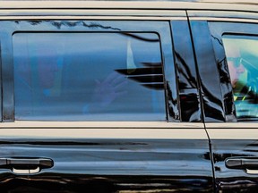 Former U.S. President and 2024 hopeful Donald Trump waves from inside his SUV on his way to the E. Barrett Prettyman U.S. Courthouse in Washington, DC, on August 3, 2023, ahead of his arraignment.