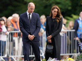 William and Catherine, the Prince and Princess of Wales, view floral tributes to late Queen Elizabeth II left by members of the public at the gates of Sandringham House in Norfolk, Sept. 15, 2022.