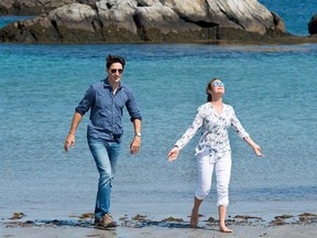 Justin Trudeau and Sophie Gregoire walk on the beach at Kejimkujik Seaside National and Historic Park in Port Joli, N.S.