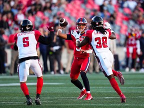 Montreal Alouettes quarterback Caleb Evans (5) lines up a pass while taking on the Ottawa Redblacks