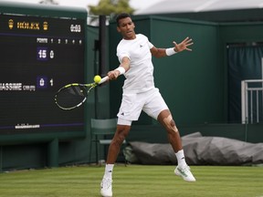 Canada's Felix Auger-Aliassime returns the ball to Michael Mmoh during their first round men's singles match on day one of the Wimbledon tennis championships in London, Monday, July 3, 2023.