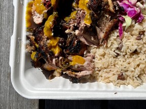 Jerk chicken, rice and peas and slaw from the Burrell Farm stand at the Ottawa Farmers Market at Lansdowne Park.