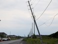 A power line sways in the wind in Ottawa on July 13, 2023, after nearly being taken down during a storm.